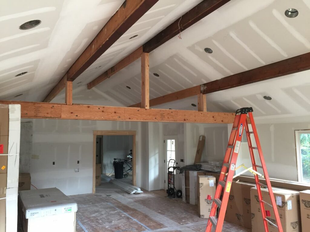 Exposed Doug Fir Structural Framing in a Vaulted Great Room Before White Oak Beam Wrapping by Creatively Done Homes Improvements in Sea Cliff Ny