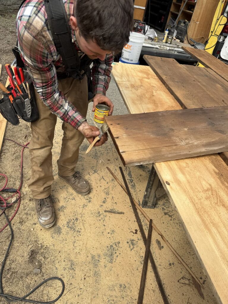Staining Cut Edges of Reclaimed Barn Wood Planks with Minwax Before Installation by Creatively Done Homes Improvements