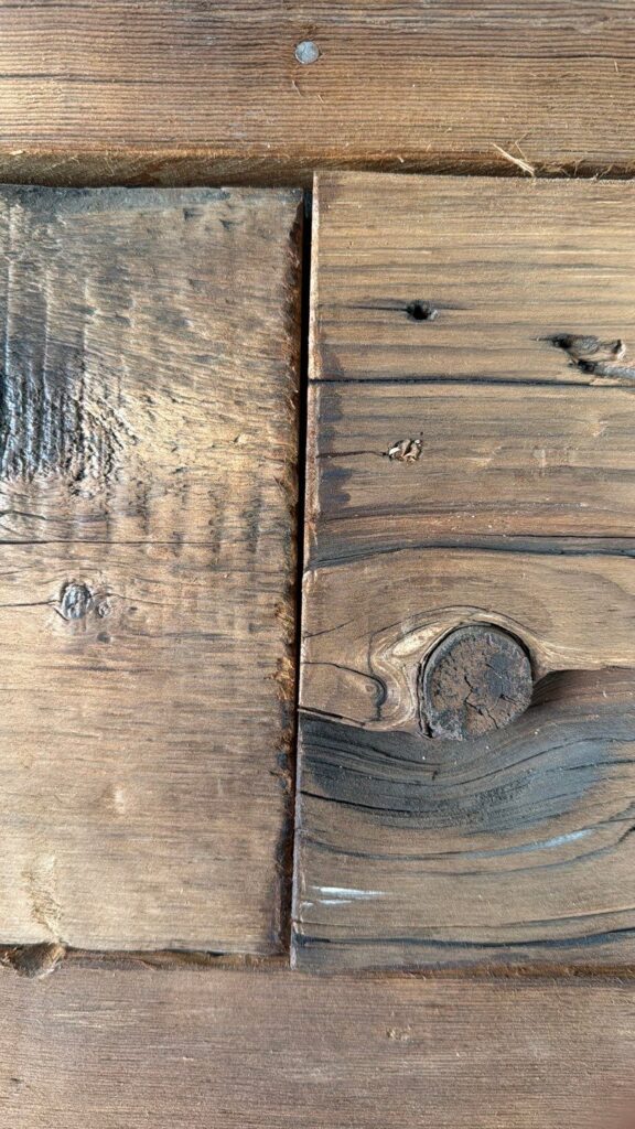 Hand Distressed Butt Joint on Reclaimed Barn Wood Wall Showing Color Matched Stain Blending Seamlessly by Creatively Done Homes Improvements