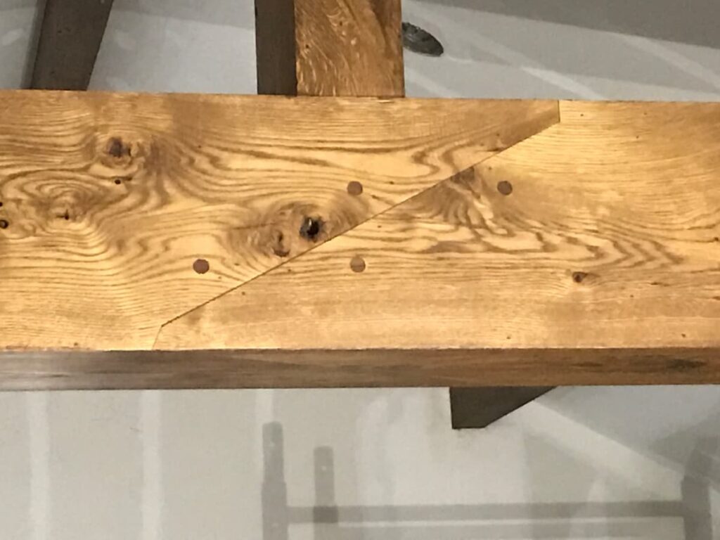 Hand fabricated Walnut Dowels in Angled Lap Joint on Custom White Oak Beam Wrapping in Sea Cliff Ny by Creatively Done Homes Improvements