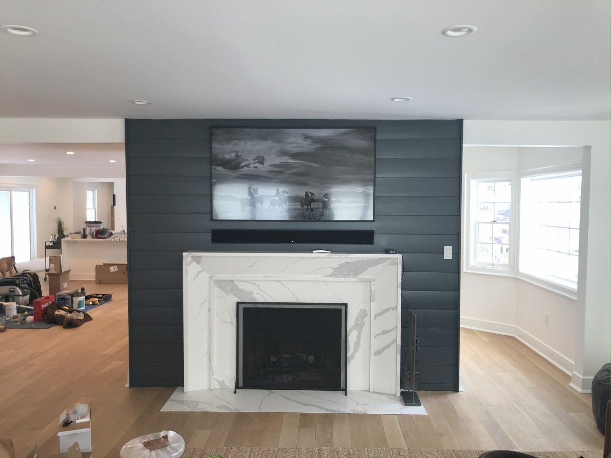 Custom Calacatta Marble Fireplace Surround with Shiplap Accent Wall and Inset Hearth in Syosset Ny by Creatively Done Homes Improvements