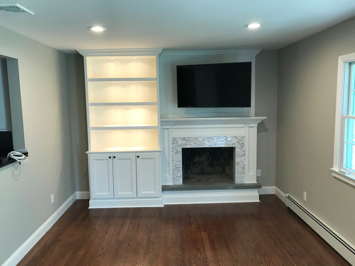 Custom Fireplace Surround with Built in Shelving Shaker Doors and Raised Blue Slate Hearth in Woodbury Ny by Creatively Done Homes Improvements