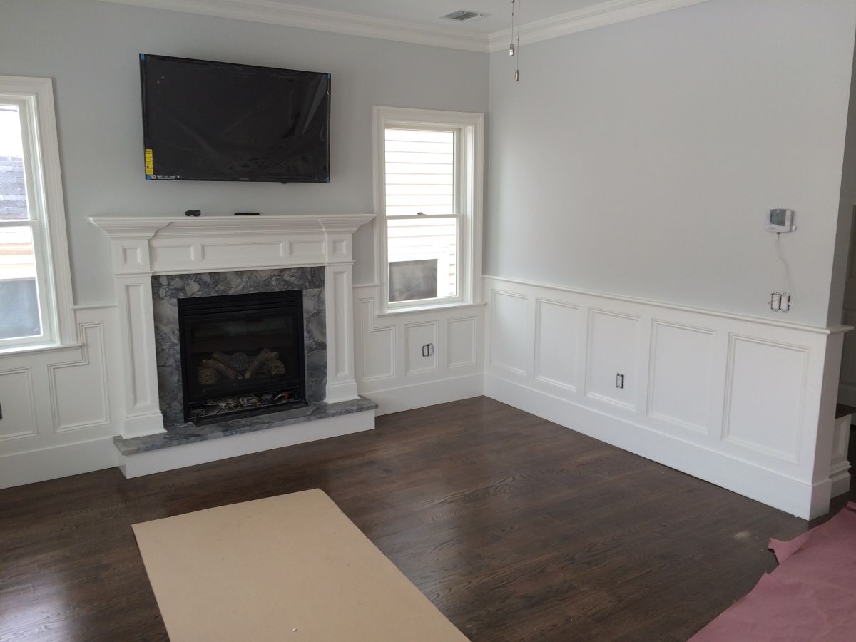 Traditional Gas Fireplace Surround with Raised Hearth Grey Marble and Wainscoting in Garden City Ny by Creatively Done Homes Improvements