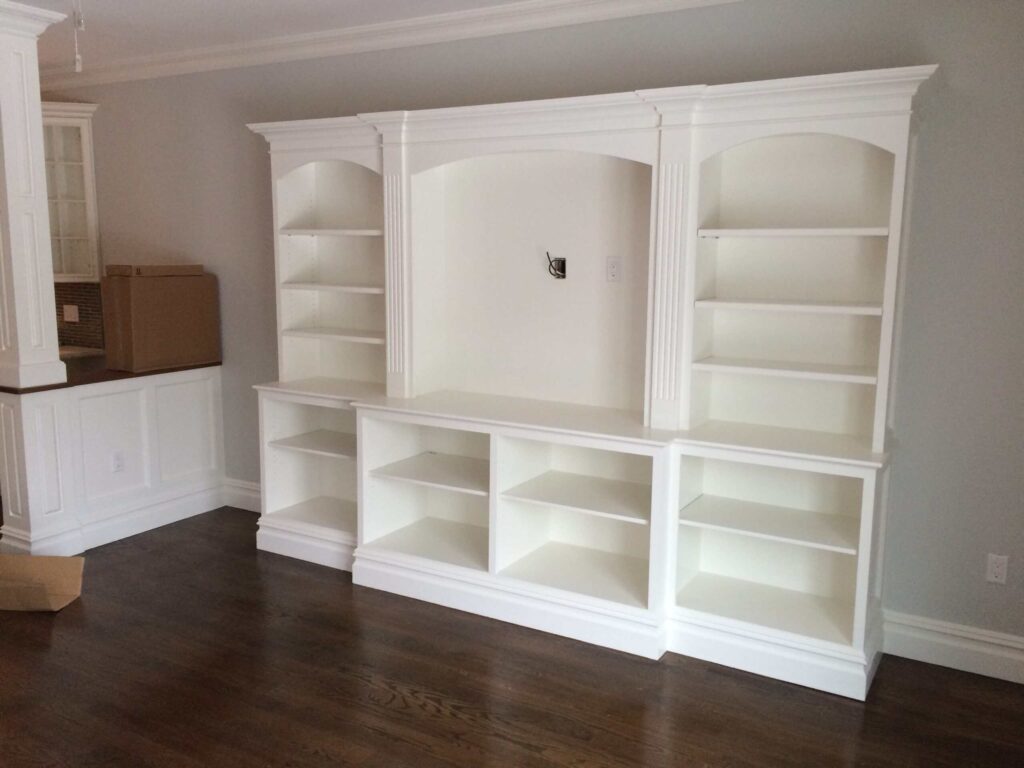 Roslyn NY Built-In Entertainment Center - Creatively Done Homes Improvements Inc. Custom Painted Built in Entertainment Center with Arched Bookcases and Fluted Pilasters in Roslyn Ny by Creatively Done Homes Improvements