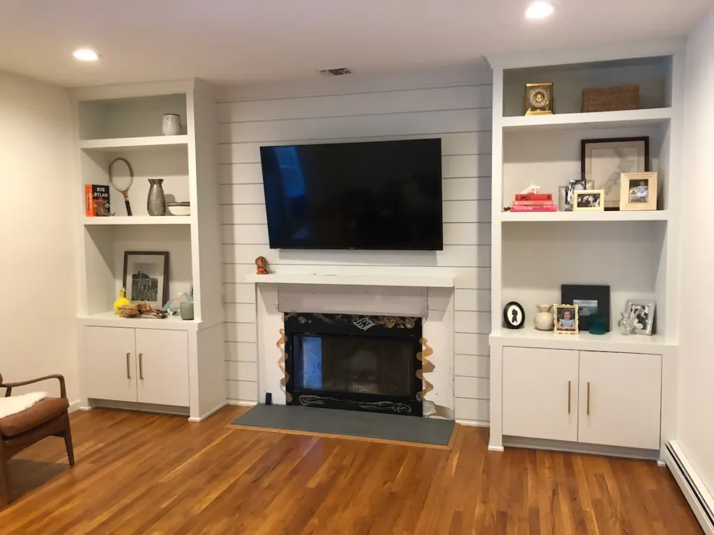 fireplace-shiplap-wall-built-in-bookcases-locust-valley-ny - Creatively Done Homes Improvements Inc. Shiplap Fireplace Wall with Custom Built in Bookcases and Lower Cabinets in Locust Valley Ny by Creatively Done Homes Improvements
