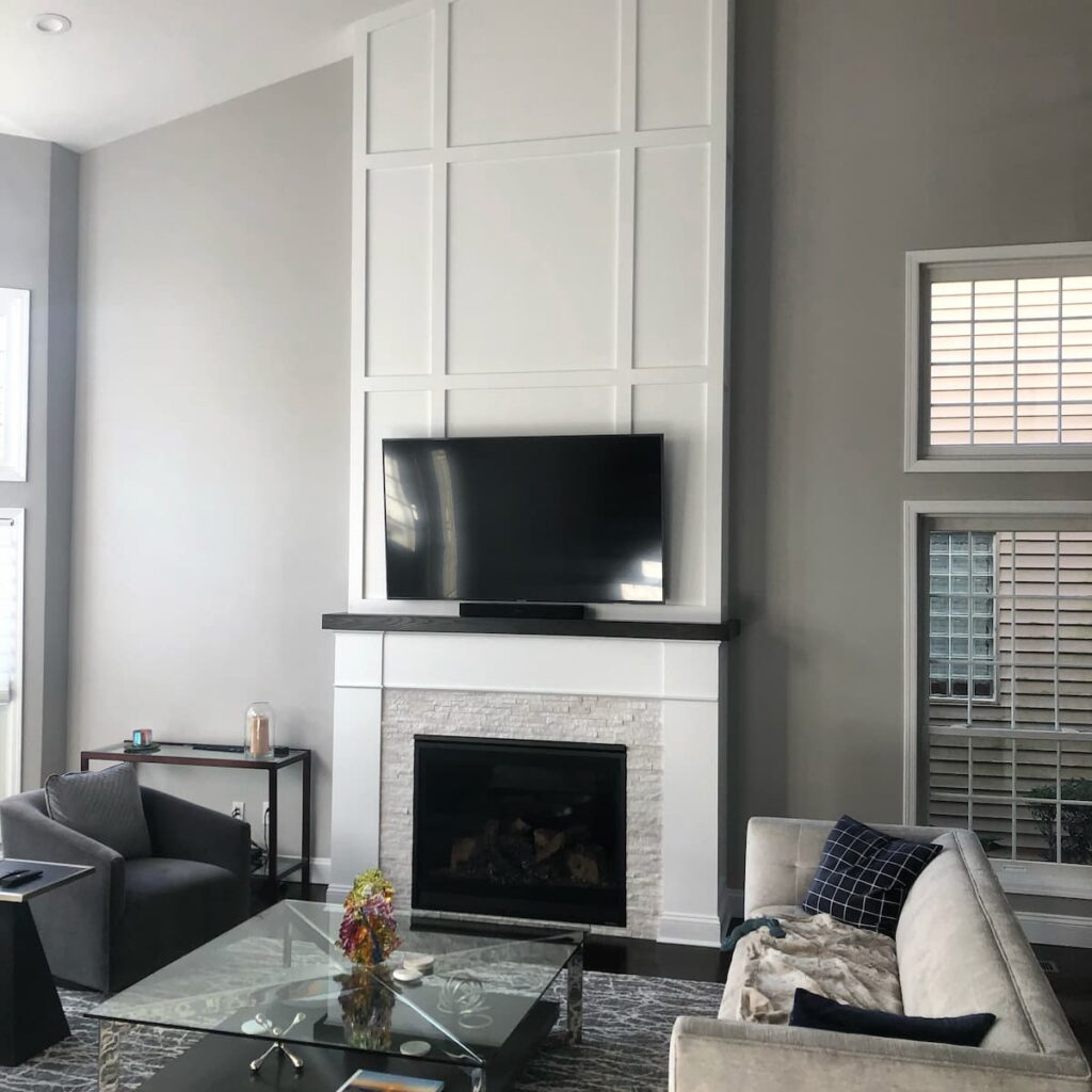 Plainview NY Floor-to-Ceiling Fireplace Wall - Creatively Done Homes Improvements Inc. Floor to ceiling Board and Batten Fireplace Wall with Stacked Stone Surround in Plainview Ny by Creatively Done Homes Improvements