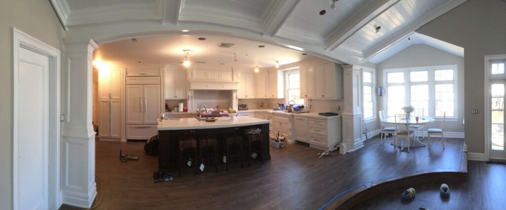 Nassau County NY Open Kitchen Archway - Creatively Done Homes Improvements Inc. Open Kitchen Viewed Through a Wide Cased Archway with Paneled Columns in Nassau County Ny by Creatively Done Homes Improvements